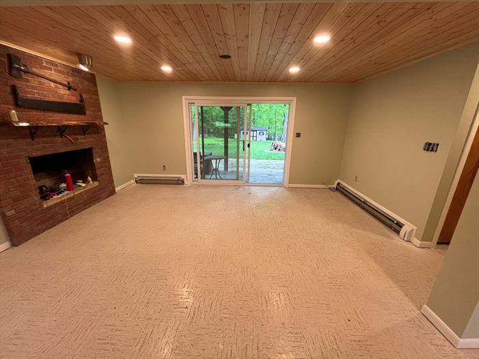 Fireplace wall and sliding door to the patio