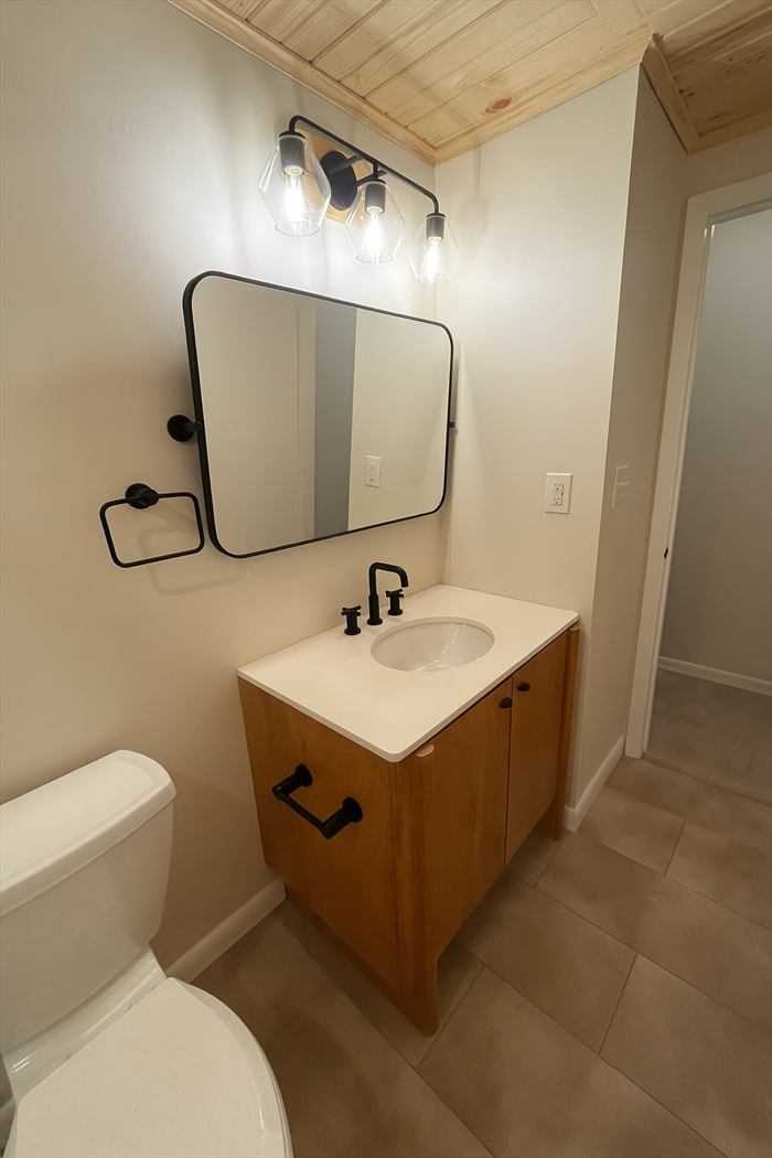 Black-framed mirror over the vanity