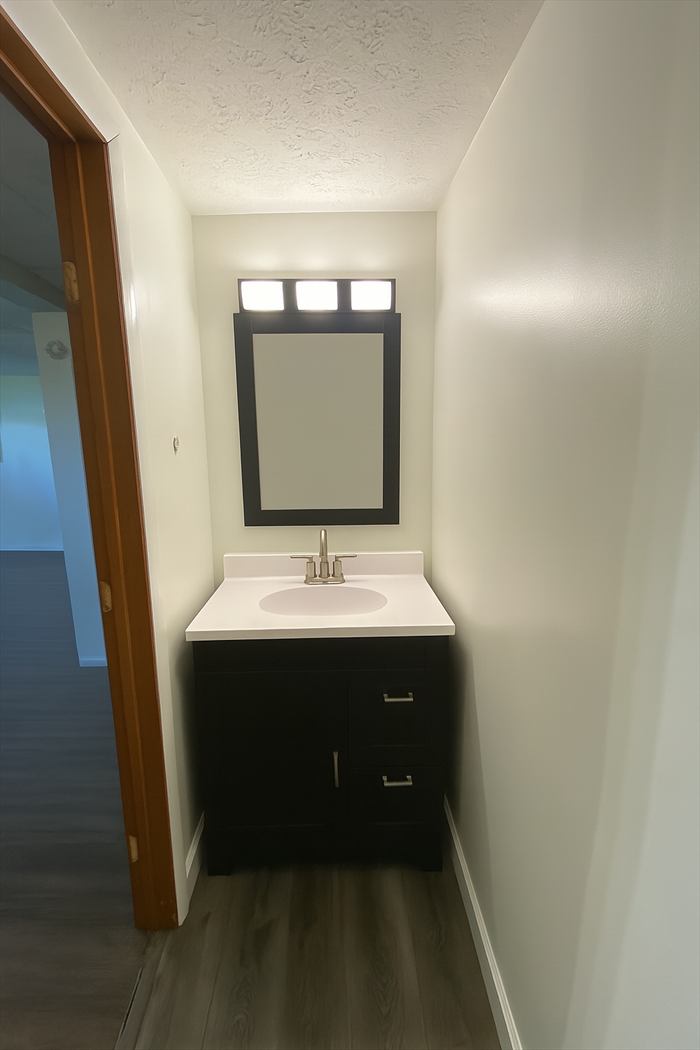 Dark vanity with a new mirror and lights