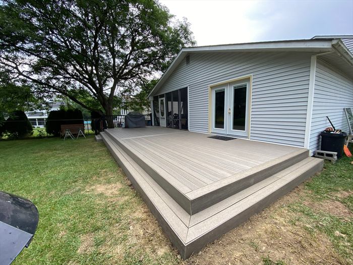 Low composite deck across the back of the house