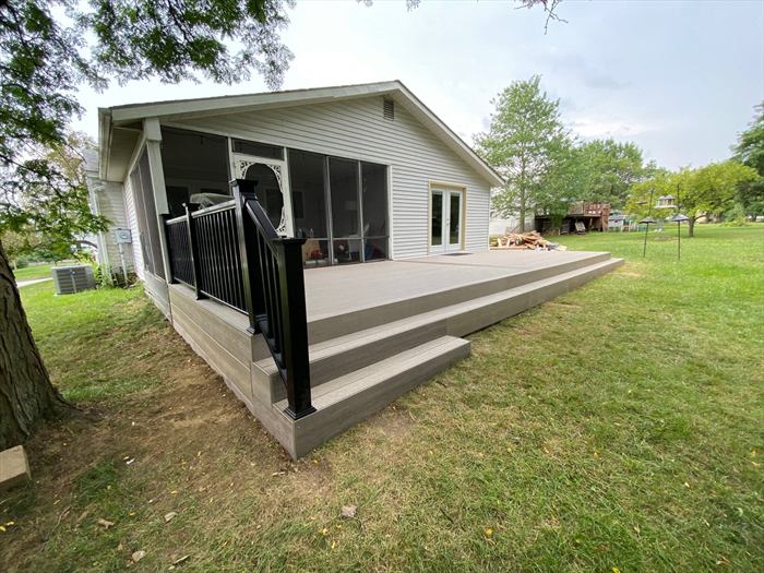 Deck edge and screened porch from the yard