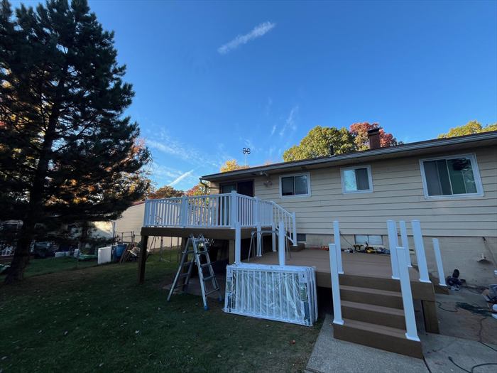 New deck and railing on a brick ranch