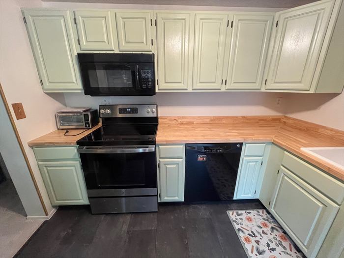 Sage cabinets, butcher-block counters and a new range